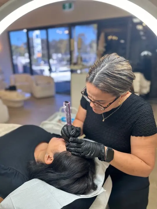 Maggie tattooing brows in the studio