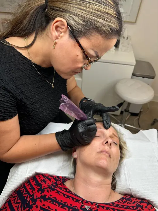 Maggie mapping a client's brows